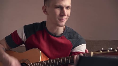 Young Adult Playing Acoustic Guitar