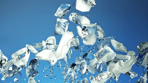 Pieces of Ice with Splashes of Water Soar Up and Fall Filmed is Slow Motion 1000 Fps
