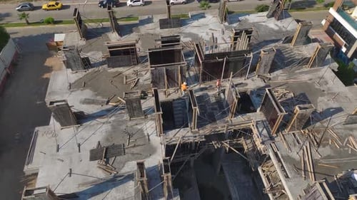 Aerial View Busy Construction Site With Cranes and Workers Building a HighRise