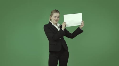 caucasian business blond girl isolated on green happy with blank sign