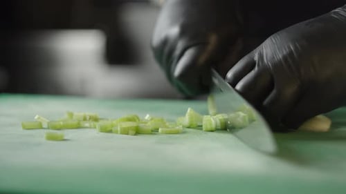 Chef Slices Fresh Green Onions with Sharp Knife
