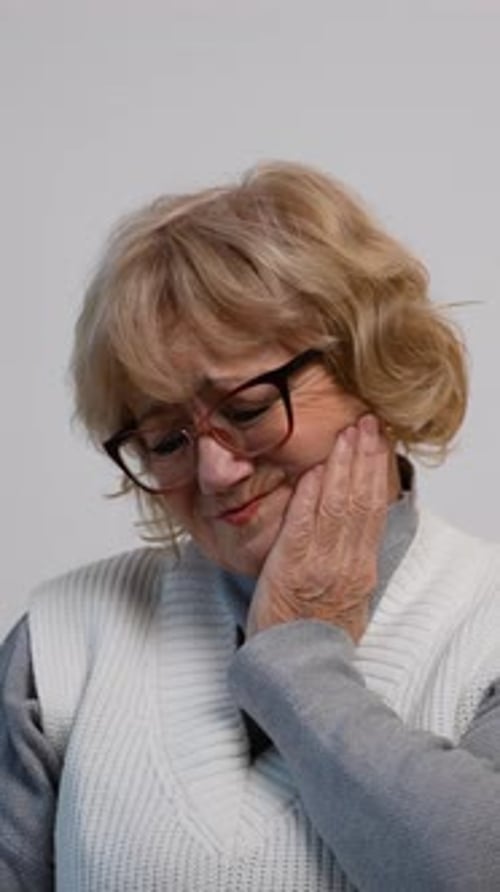 Woman Holding Her Face Indoors