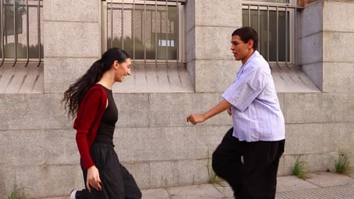 Young Energetic Couple Dancing Hip Hop Together on an Urban Street