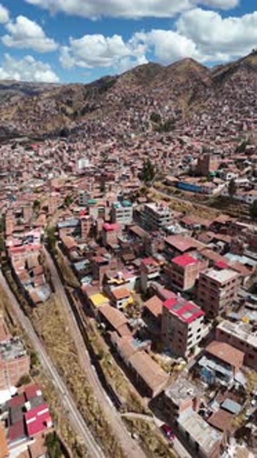 Cusco city residential hillside area with Andean mountains, Peru, aerial view