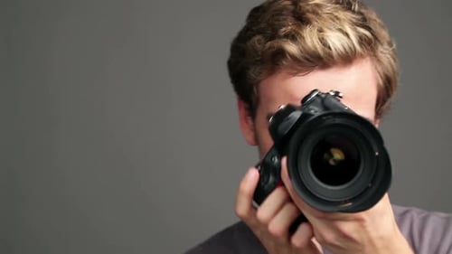 Enthusiastic Young Man Poses with Camera