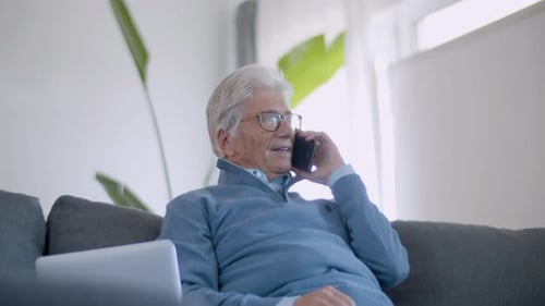 Senior Man Chatting on Phone Indoors