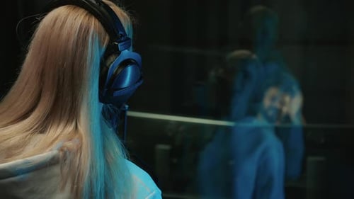 Professional Female Singer and Sound Engineer Recording Musical Album in Studio Woman and Man