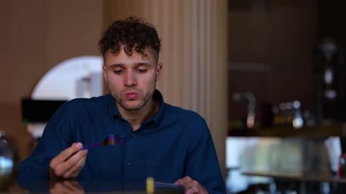 Close Up of Caucasian Handsome Man Having Lunch or Supper Eating in Restaurant Alone
