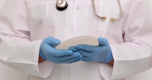 Doctor Holding Silicone Breast Implant