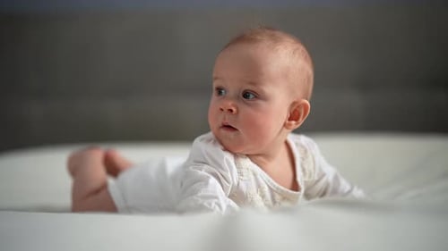 Sweet Infant Lying on Stomach in Close Up