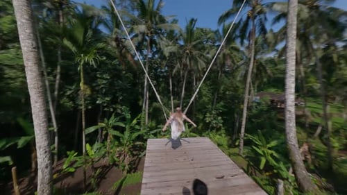 Woman Swinging on Tropical Jungle Swing