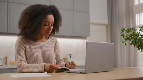 Woman Works From Home at Kitchen Island