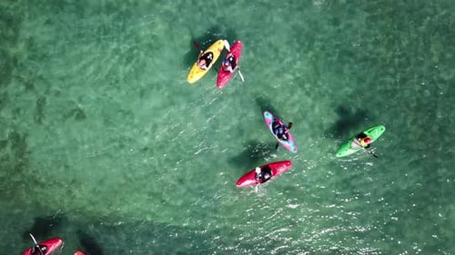 drone shot, top down angle of a group of kayaks in the water, Auckland, New Zealand