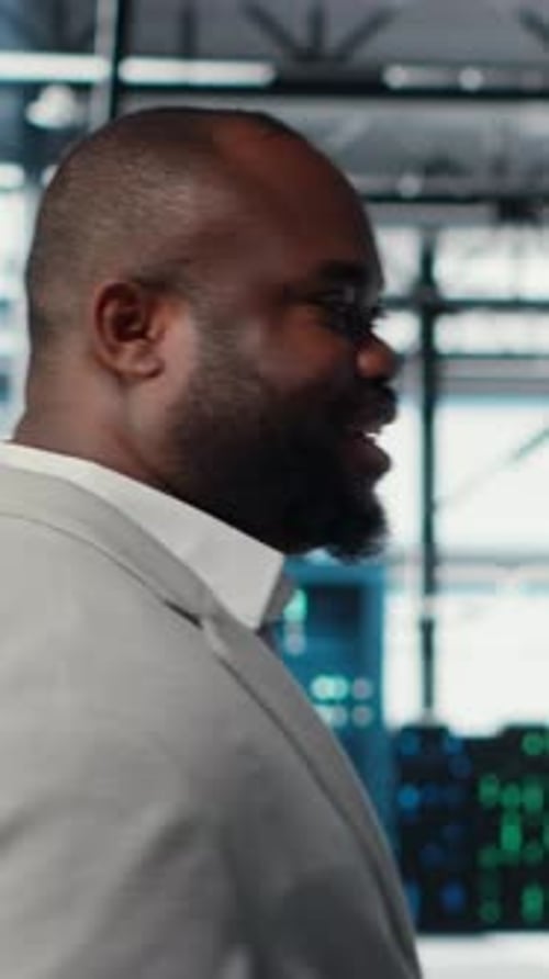 Vertical Video Engineer Walking in Data Center Facility Doing Inspection on Hardware Tech