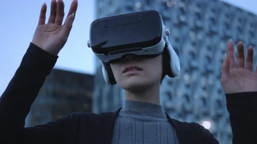 Woman Using VR Headset Outdoors in Urban Setting