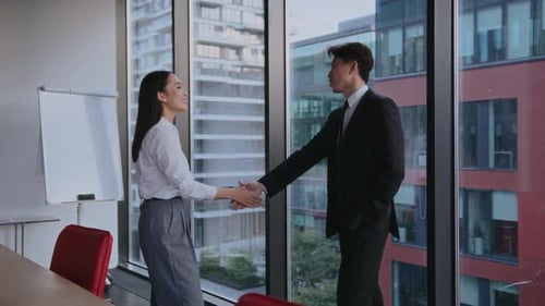 Business Handshake in a Modern Office Environment
