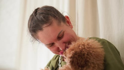 Woman Smiles As Dog Licks Her Nose During Playful Nose Touch Moment