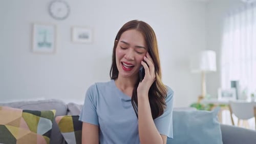 Woman Talking on Phone at Home on the Couch