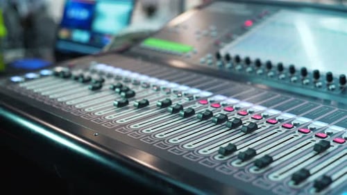 Audio Mixer in a Studio, the Automatic Knobs Moving Up and Down