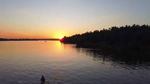 Paddleboarding at Sunset on Calm Waters
