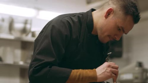 Chef Prepares Gourmet Salad in Restaurant Kitchen