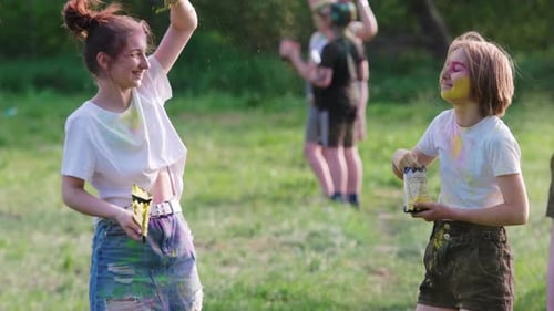 Youth Celebrate Holi Festival Outdoors with Color Powder