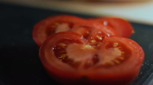 Sliced Tomato on Black Surface Close-Up