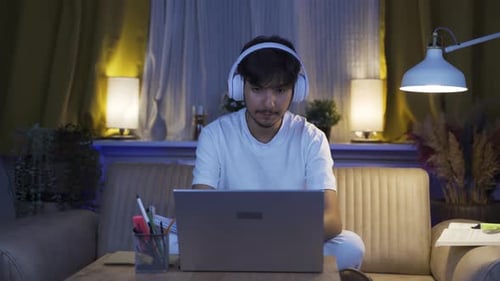 A male student gets upset when he sees bad exam results on the laptop.