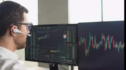 Successful Trader is Working with Multiple Computer Screens Full of Charts and Data Analysis and