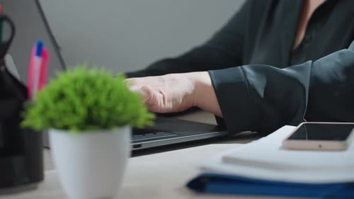 Close Up of Woman Typing on Laptop at Office Desk