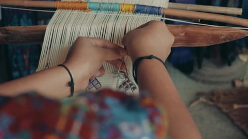 Woman Weaver At Work On Her Loom In Guatemala, Central America - high angle, close up