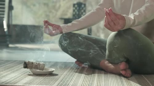 Woman Meditating with Sage Burning