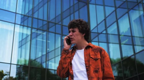 Angry and Agressive Man Screams and Talks on the Phone Curses and Quarrels in Rage Yelling at the