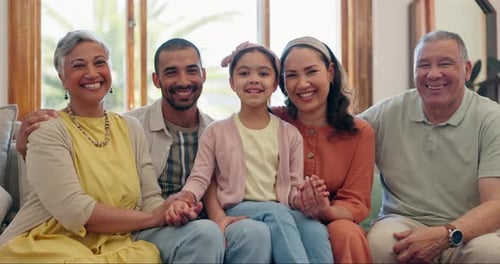 Smiling Multigenerational Family Posing Together on Sofa