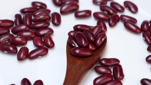 Kidney Beans Piled on Spoon on White Surface