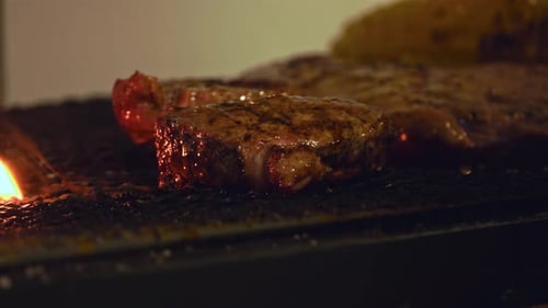 Sizzling Beef Perfection: Close-Up of a Juicy Steak Grilling to Flavorful Excellence