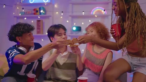 Friends Sharing Pizza at an Indoor Party