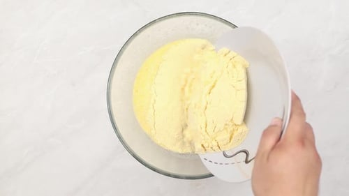 Mixing eggs with corn flour in flat lay look.
