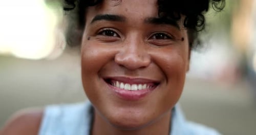 Close Up of Smiling Young Woman with Curly Hair