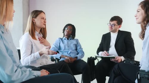 Group of people in a meeting sitting indoors