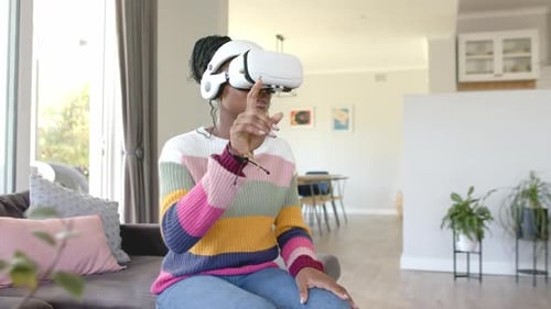 Woman Uses Virtual Reality Headset in Living Room