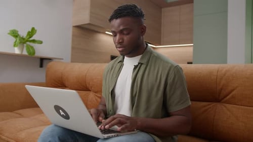 Young Adult Working on Laptop at Home