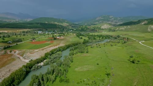 Aerial view river runs through a green valley