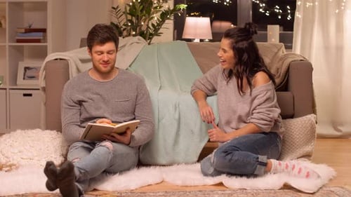 Couple in cozy home writing ideas together