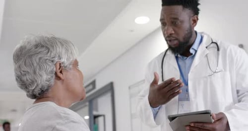 Doctor Consulting with Senior Patient in Hospital Setting