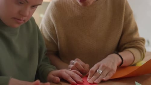 Woman and Teen Making Origami Paper Together