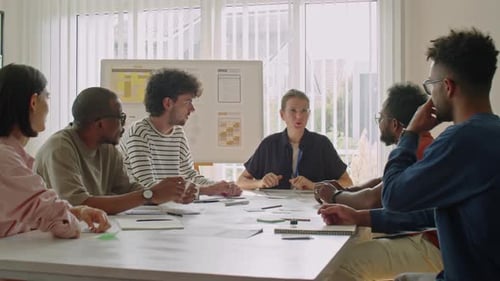 Diverse Team Meeting Around Conference Table in Office