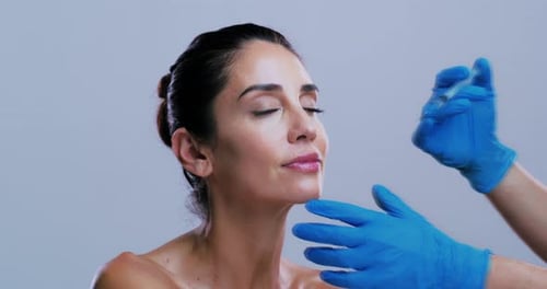 Mature woman, hands and lip filler in studio for dermatology, injection