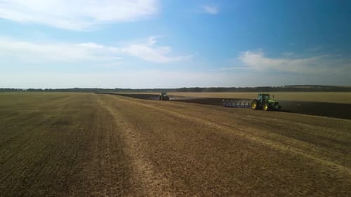 Tractors plowing the field in Ukraine