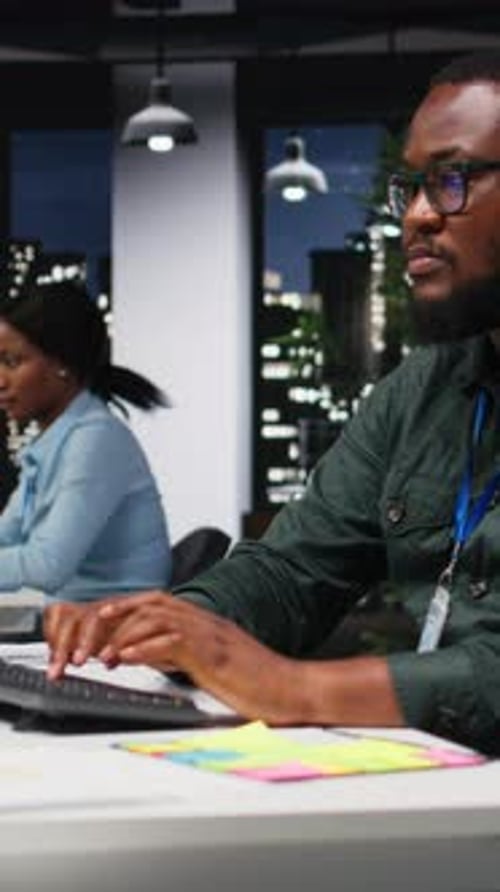 Vertical Video Black Coworkers Team Monitoring Forecast Data for a New Monthly Analysis